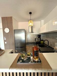 a kitchen with two glasses of alcohol on a tray at Ti Paradis 1 in Les Trois-Îlets