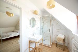 a white bathroom with a shower and a sink at Apartamenty Heweliusz House in Stegna +66 photos