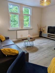 a living room with a couch and a table at City und Natur - Ferienwohnung an der Itz in Coburg