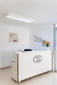 a white counter with a sign on it in a room at Hotel Tuna in Akçay
