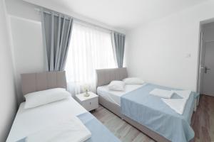 a bedroom with two beds and a window at Hotel Tuna in Akçay +38 photos