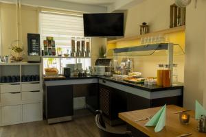 a kitchen with a counter with food on it at Hotel Rendsburg in Rendsburg +21 photos