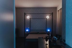 a bedroom with a bed with two lights on it at Vistamare Suites in Lido di Latina