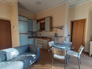 a living room with a couch and a table and chairs at Maria Carolina Suite in Caserta