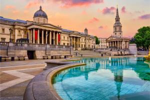 a large building with a pool in front of it at Posh Soho Studio Large Windows by Oxford St, Mayfair W1 in London