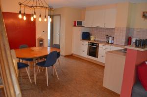 a kitchen with a table and chairs in a room at Gîte O l'Hore in Malmedy +22 photos