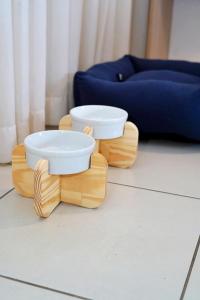 a pair of wooden bowls sitting on top of a floor at Beach Class Convention By MAI in Recife