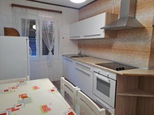a kitchen with a table and a counter top at Berto in Nerezine