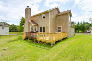 a house with a large deck in the yard at Family Retreat with 2 Game Rooms and Deck in Long Pond in Long Pond