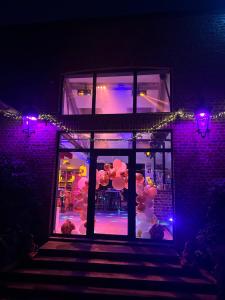 een gebouw met 's nachts een verlicht raam bij Gîte à la ferme in Houplin-Ancoisne +24 foto's