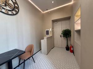 a room with a table and a clock on the wall at Luxe roma in Rome