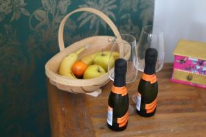 two bottles of wine next to a basket of fruit at West ave exeter in Exeter