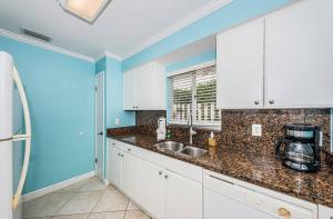 a kitchen with white cabinets and a sink at Cozy Home Near the Beach - Aloha Kai #37 - Roelens in Siesta Key