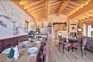 una sala da pranzo con un lungo tavolo e sedie di Chalet Stella Montis - Luxe et Proximité des Pistes a Praranger