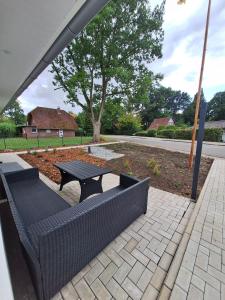a patio with a bench and a picnic table at Ferienhaus Jannik in Hüde