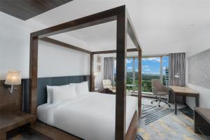 a hotel room with a bed and a desk and a desk at Country Inn & Suites By Radisson Navi Mumbai in Navi Mumbai +68 photos