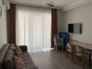 a living room with a couch and a table at Astara Terrace 2-3 in Astara