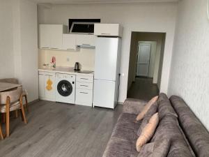 a living room with a couch and a kitchen at Astara Terrace 2-3 in Astara