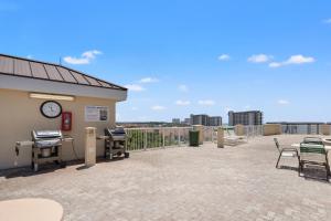 a patio with a clock on the side of a building at Grand Panama by Panhandle Getaways in Panama City Beach
