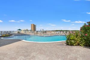 a swimming pool at a resort with a building in the background at Grand Panama by Panhandle Getaways in Panama City Beach +3 photos