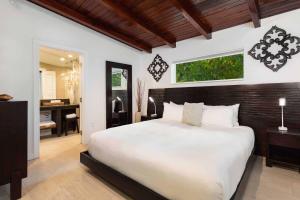 a bedroom with a large white bed and a desk at Largo Resort in Key Largo +45 photos