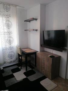 Camera con scrivania, TV e tavolo di Guest House Plovdiv a Plovdiv