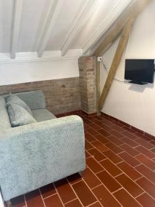 a living room with a couch and a flat screen tv at Casa Adega Do Mosteiro - Turismo Rural in Caldas da Rainha