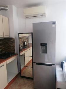 a kitchen with a stainless steel refrigerator in a room at Guest House Plovdiv in Plovdiv