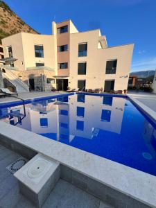 a swimming pool in front of a building at Blue Haven apartment 2 in Tušupi