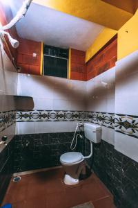 a bathroom with a toilet in a room at Shanti krishna Residency Gokarna in Gokarna