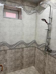 a bathroom with a shower with a window at Villa Vip in Gabala +5 photos