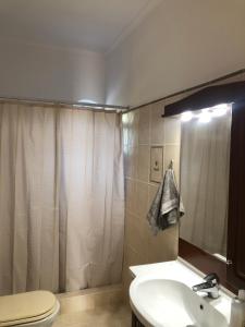 a bathroom with a sink and a toilet and a shower at Villa Zante Estrella in Kalamaki