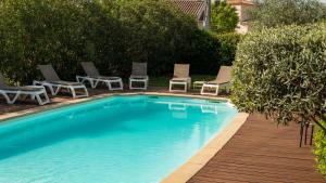 a swimming pool with chaise lounge chairs and ahaps at Patio De Violette in Uzès
