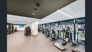 a gym with treadmills and ellipticals in a building at 14D Abnb-Style Elegant CBD Sanctuary with Balcony, Pool and Skyline Views in Melbourne