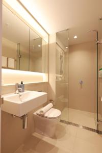 a bathroom with a sink and a toilet and a shower at 14D Abnb-Style Elegant CBD Sanctuary with Balcony, Pool and Skyline Views in Melbourne