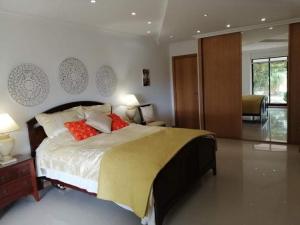 a bedroom with a large bed with red pillows at casa do lago in Monchique +21 photos