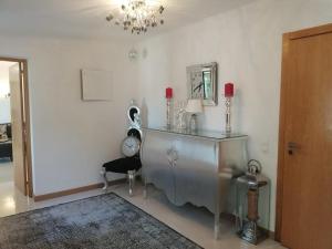 a room with a table and a mirror and a chair at casa do lago in Monchique