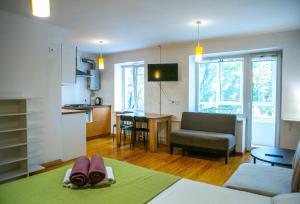 a kitchen and a living room with a couch and a table at Doba In Ua Centre Apartments in Dnipro