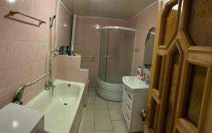 a bathroom with a tub and a shower and a sink at Садиба ''У Марії'' in Bystrets +3 photos