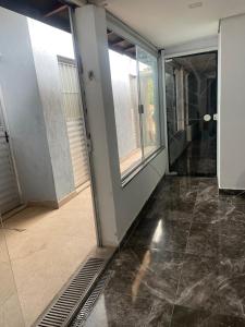 an empty room with a glass door and a hallway at Spazzio hostel in São José dos Campos