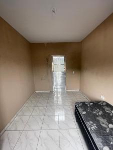 a empty room with a bed and a hallway at Spazzio hostel in São José dos Campos