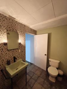 a bathroom with a white toilet and a sink at Napoli Centro in Santa Ana +55 photos