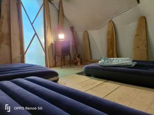 a room with two beds in a tent at tipy 2 in La Celle-sous-Gouzon