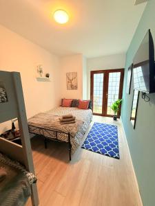 a living room with a bed and a blue rug at Chiswick Guest Rooms in London