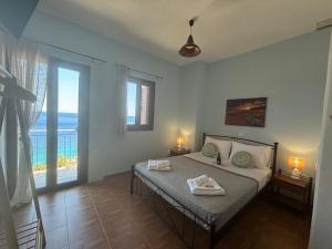 a bedroom with a bed with two towels on it at Ticallisti Rooms by Villa Lagkadaki in Agriliá