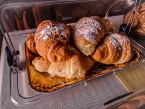 a plastic container filled with croissants and other pastries at b&b Don Peppe - Don Ilario in San Mauro Cilento