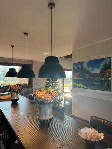 a dining room table with vases of flowers on it at Luxury Villa Countryside in Bettola