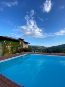 a swimming pool with a view of a house at Luxury Villa Countryside in Bettola
