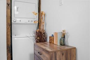 a mirror on top of a wooden dresser next to a refrigerator at The Heartwood Hideaway-Charming Cabin Getaway-Trails, Creek, and Starry Nights in Primm Springs +75 photos