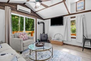 a living room with a couch and a table at The Heartwood Hideaway-Charming Cabin Getaway-Trails, Creek, and Starry Nights in Primm Springs